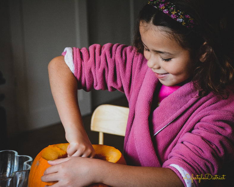lula-June happily carving her big pumpkin for halloween