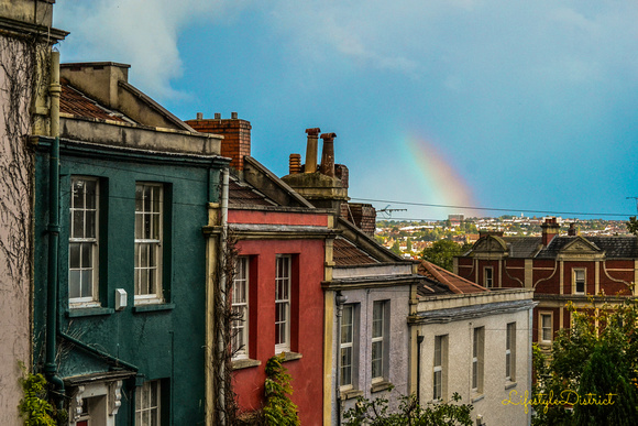 A rainbow arches over some Bristolian houses on Ninetree Hill