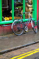 A lovely bike leans against the wall of a farm shop