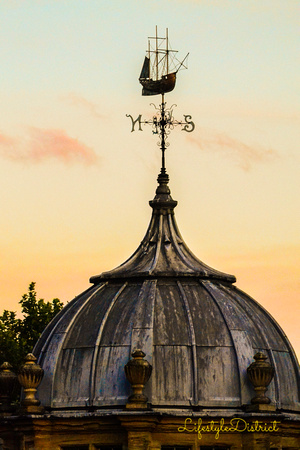 A weather vane shaped as a pirate boat inspires the passers by