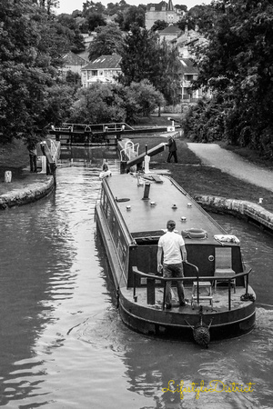A narrow boat navigate the waters in the canal in Bath