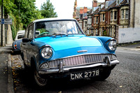 An blue vintage car from the 1960's is parked on a Bristol street