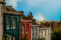 A rainbow appears over coloured houses in Bristol
